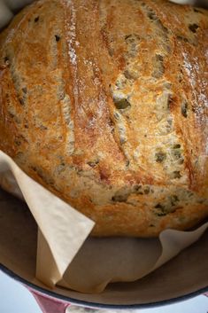 a loaf of bread sitting on top of a pan covered in wax paper and napkins