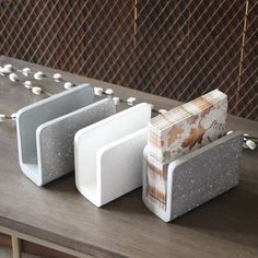 four white and gray objects sitting on top of a wooden table