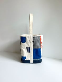 a blue and white tote bag sitting on top of a table