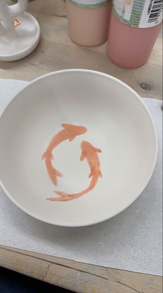 a white bowl sitting on top of a wooden table