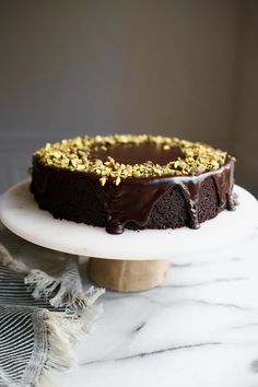 a chocolate cake sitting on top of a white plate
