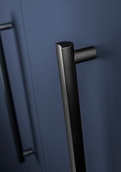 an image of a black handle on a blue door