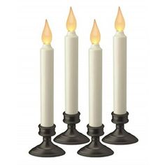 three white candles sitting on top of each other