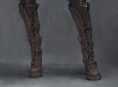 the legs and boots of a woman in high heeled boots, with chains on them