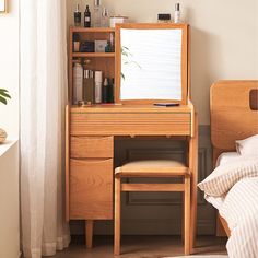 a bedroom with a bed, desk and mirror