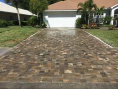 a brick driveway in front of a house