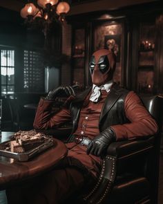 a man in a suit and mask sitting at a table