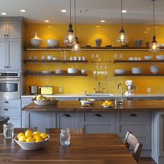 a kitchen filled with lots of counter top space next to a wooden dining room table