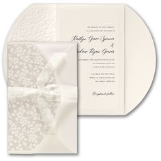 a white wedding card with a bow on it