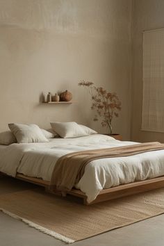 a large bed sitting on top of a wooden floor next to a wall mounted shelf