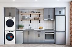 a kitchen with grey cabinets and appliances in front of a blue sign that says help