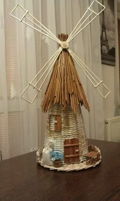 a house made out of straw sitting on top of a table