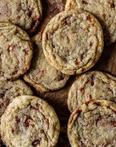 a bunch of cookies sitting on top of a piece of wax paper