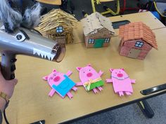 a blow dryer is being used to make paper cut out houses with pigs on them