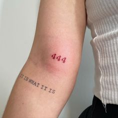 a person with a tattoo on their arm that says 444 it's what it is