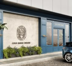 a blue car is parked in front of the entrance to a building with palm trees