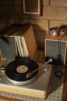 an old record player sitting on top of a table