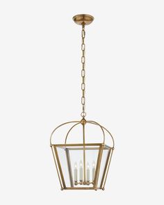 a brass hanging light fixture with four candles in the center and two lights on each side