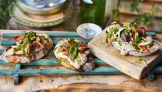 three different types of food sitting on top of a wooden tray