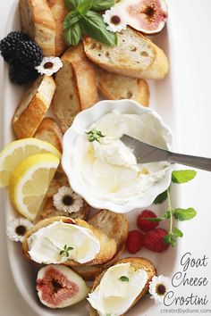 a plate with bread, cheese and fruit on it