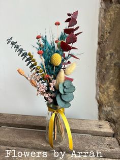 a vase filled with flowers on top of a wooden table