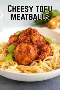 a white plate topped with spaghetti and meatballs