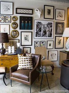 a living room filled with furniture and pictures on the wall