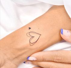 a woman's arm with a small tattoo on the left side of her arm