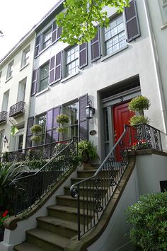 an apartment building with stairs leading up to the front door