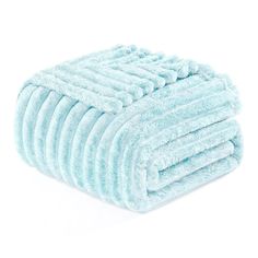 a stack of blue towels folded on top of each other in front of a white background