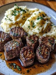 some meat and mashed potatoes on a plate