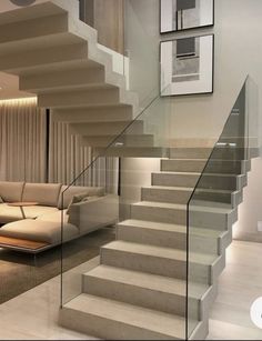 a living room filled with furniture next to a stair case