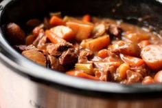 a pot filled with meat and vegetables on top of a stove