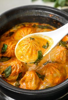 a ladle scooping some food out of a slow cooker