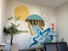 an office with a mural on the wall