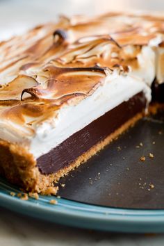 a chocolate and white dessert on a plate with one slice taken out of it's pie