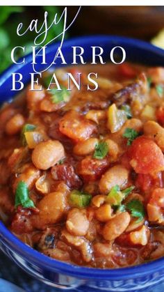 a blue bowl filled with beans and vegetables