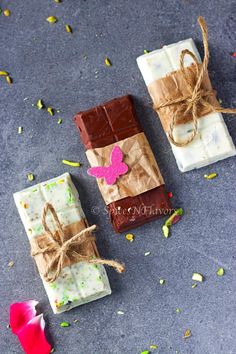 three pieces of chocolate wrapped in brown paper and tied with twine on the ground