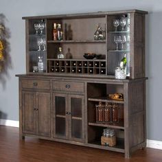 a wooden cabinet with wine glasses and bottles on it