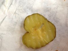 a heart shaped piece of fruit sitting on top of paper