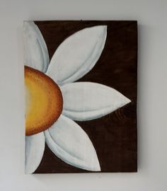 a painting on the wall with a flower painted on it's side and brown background