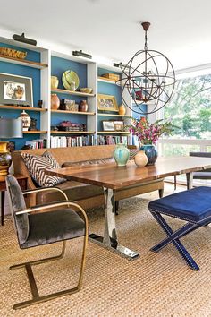 a living room filled with furniture and bookshelves