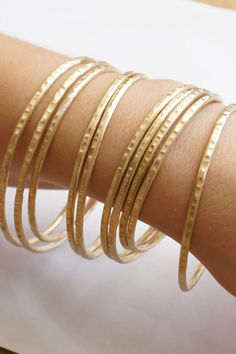 Discover our simple and minimalistic 2mm bangles, perfect for wearing solo or stacking with your favorites. Crafted from sturdy copper, brass, or solid sterling silver, these delicate eye-catchers are perfect for everyday wear. Insect Wings, Money Bouquet, Bangles Gold, Stacked Bangles, Bracelet Sterling Silver, Copper Brass, Bracelet Stack, Iphone Apps, Gold Bangles