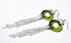 pair of green earrings on white background with chain link and dangling earwires in the shape of rings