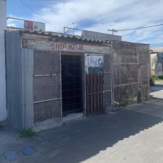 an old run down building with graffiti on the front and side doors that say shop no 13