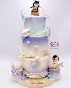 a three tiered cake with figurines sitting on the top and under it