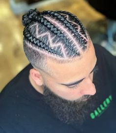 Modern Man Bun Braids with Skin Fade. This cool men’s hairstyle pairs stylish braids with a timeless man bun to achieve a fresh, trendy aesthetic. These masculine braided bun styles are popular choices for fashion-forward guys who want to stand out with a refreshing approach. Simple Braid For Men, Man Bun Hairstyles Braids, Men’s Braids With Fade Back, Mens Braided Bun, Braided Hair For Men, Man Bun Braids Black Men, Braids For Men With Fade, Man Bun Braids Kids, Men’s Braided Designs