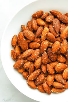 a white bowl filled with almonds on top of a table