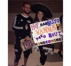 two people dressed up in costumes and holding a sign that says hey baeritoo wannas taco bout home coming?