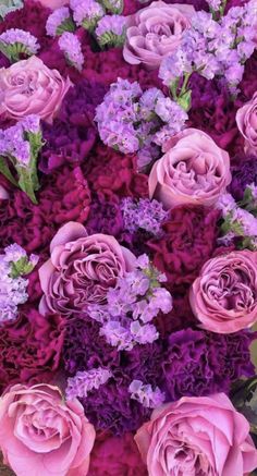 purple and pink flowers are arranged in a bouquet